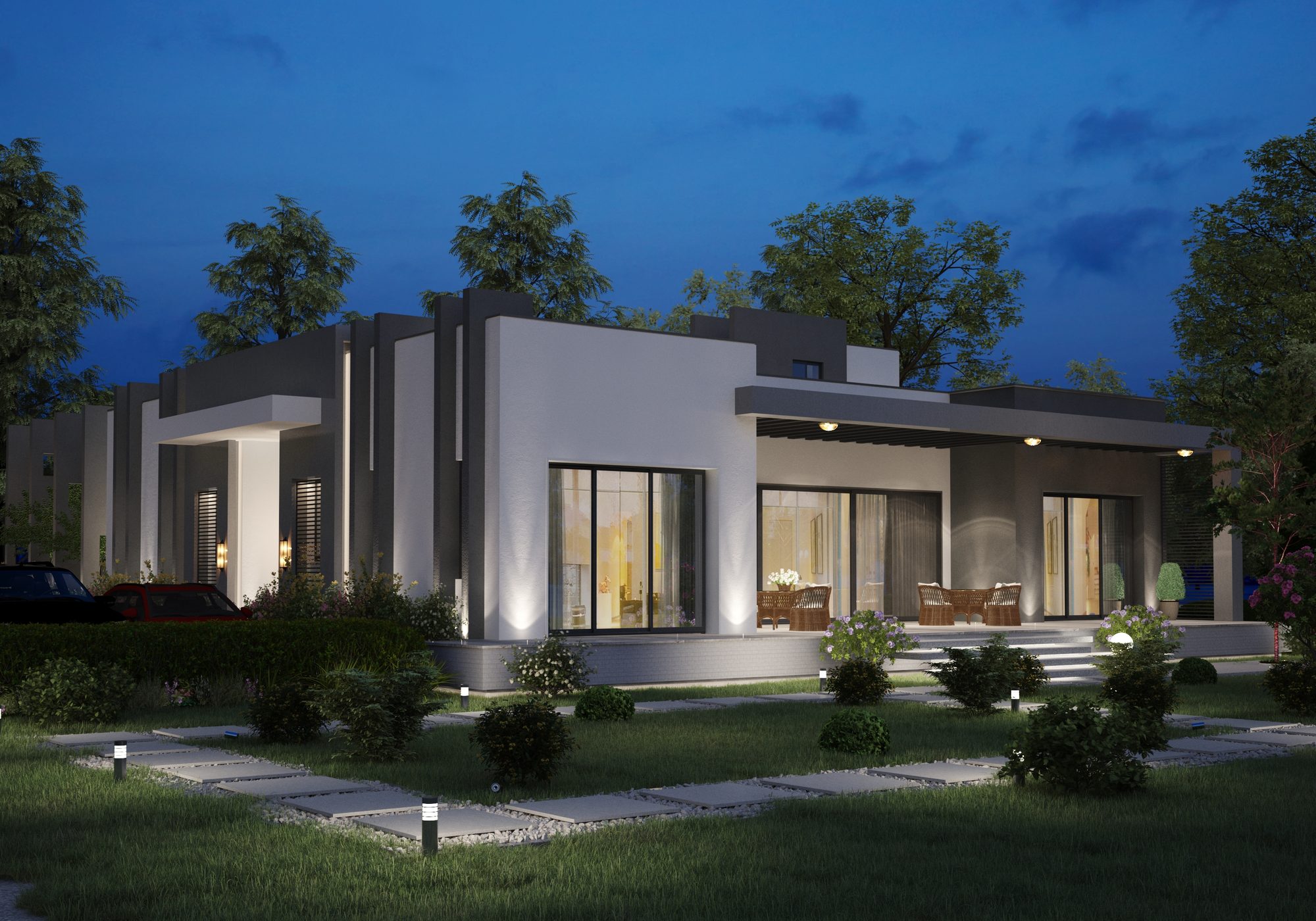 Single-storey farmhouse at dusk with layered fin walls and landscaped garden