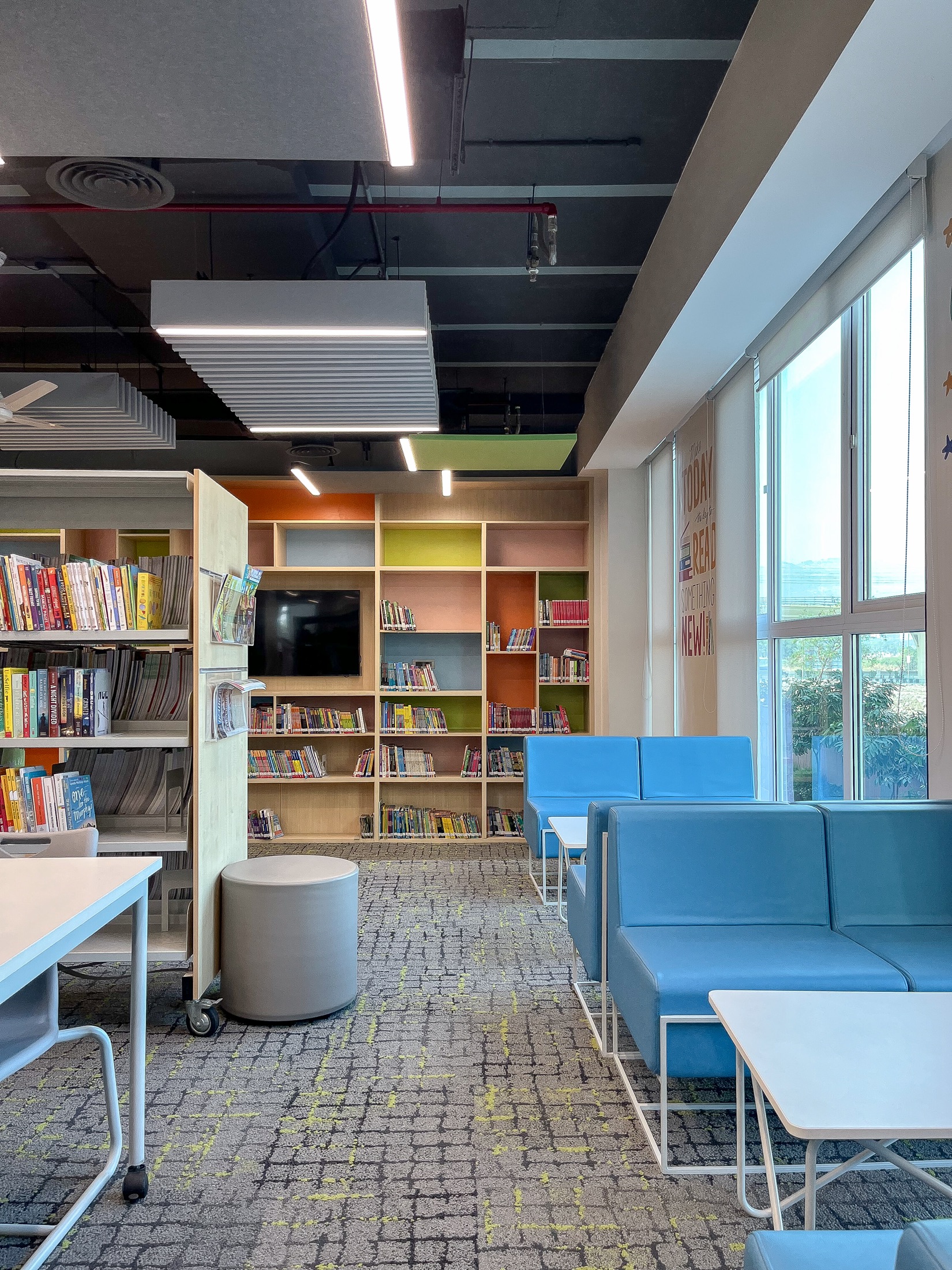 School library with colourful shelving and reading lounge seating